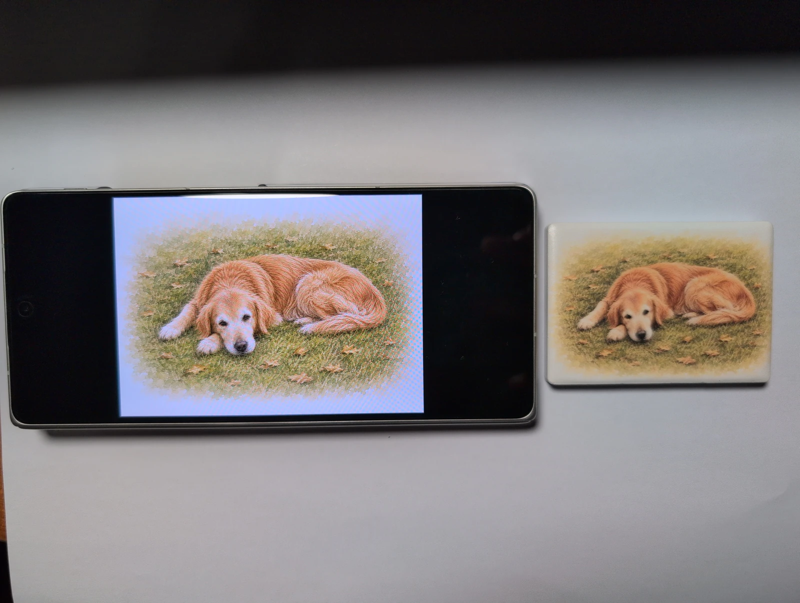 The final Qiqi artwork shown on a phone beside the printed ceramic magnet.